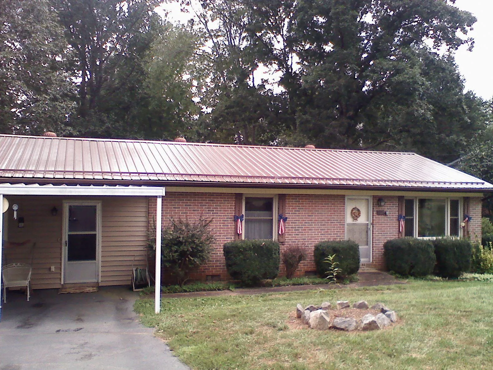 Bronze metal roof and carport on a brick ranch home — Roof Repair work by our crew in Harwood Heights